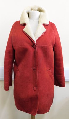 Lot 76 - A lady's red sheepskin coat, button fronted...