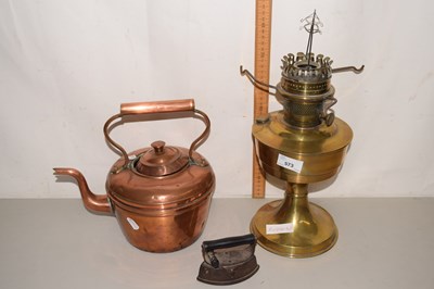 Lot 573 - An oil lamp, copper kettle and an iron