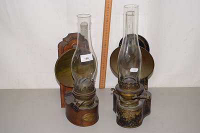 Lot 196 - Two wall mounted oil lamps and a further brass...