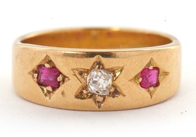 Lot 28 - A ruby and diamond ring, the 7mm deep band...