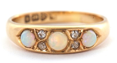 Lot 27 - An 18ct opal and diamond ring, set with three...