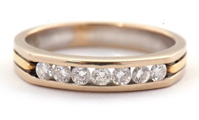 Lot 31 - A seven stone diamond ring, with channel set...