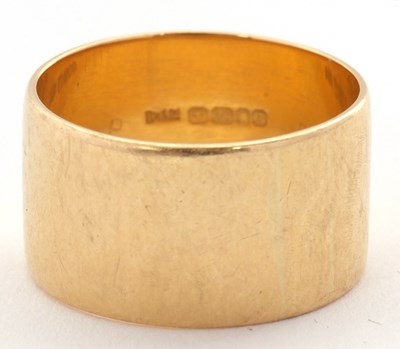 Lot 173 - An 18ct ring, 11mm wide, hallmarked London...