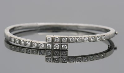 Lot 283 - A diamond bangle, the crossover style bangle...