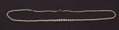 Lot 146 - A faux pearl necklace with a ruby and diamond...