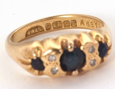 Lot 64 - An 18ct sapphire and diamond ring, with a...