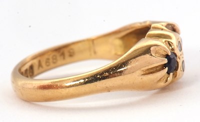 Lot 64 - An 18ct sapphire and diamond ring, with a...