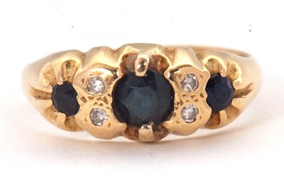 Lot 64 - An 18ct sapphire and diamond ring, with a...