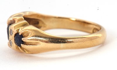 Lot 64 - An 18ct sapphire and diamond ring, with a...