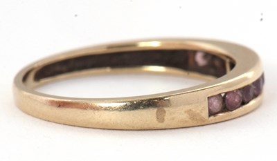 Lot 58 - A 9ct gemset ring, with channel set small...