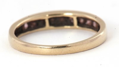 Lot 58 - A 9ct gemset ring, with channel set small...