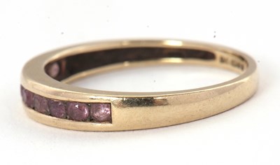 Lot 58 - A 9ct gemset ring, with channel set small...