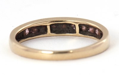 Lot 58 - A 9ct gemset ring, with channel set small...