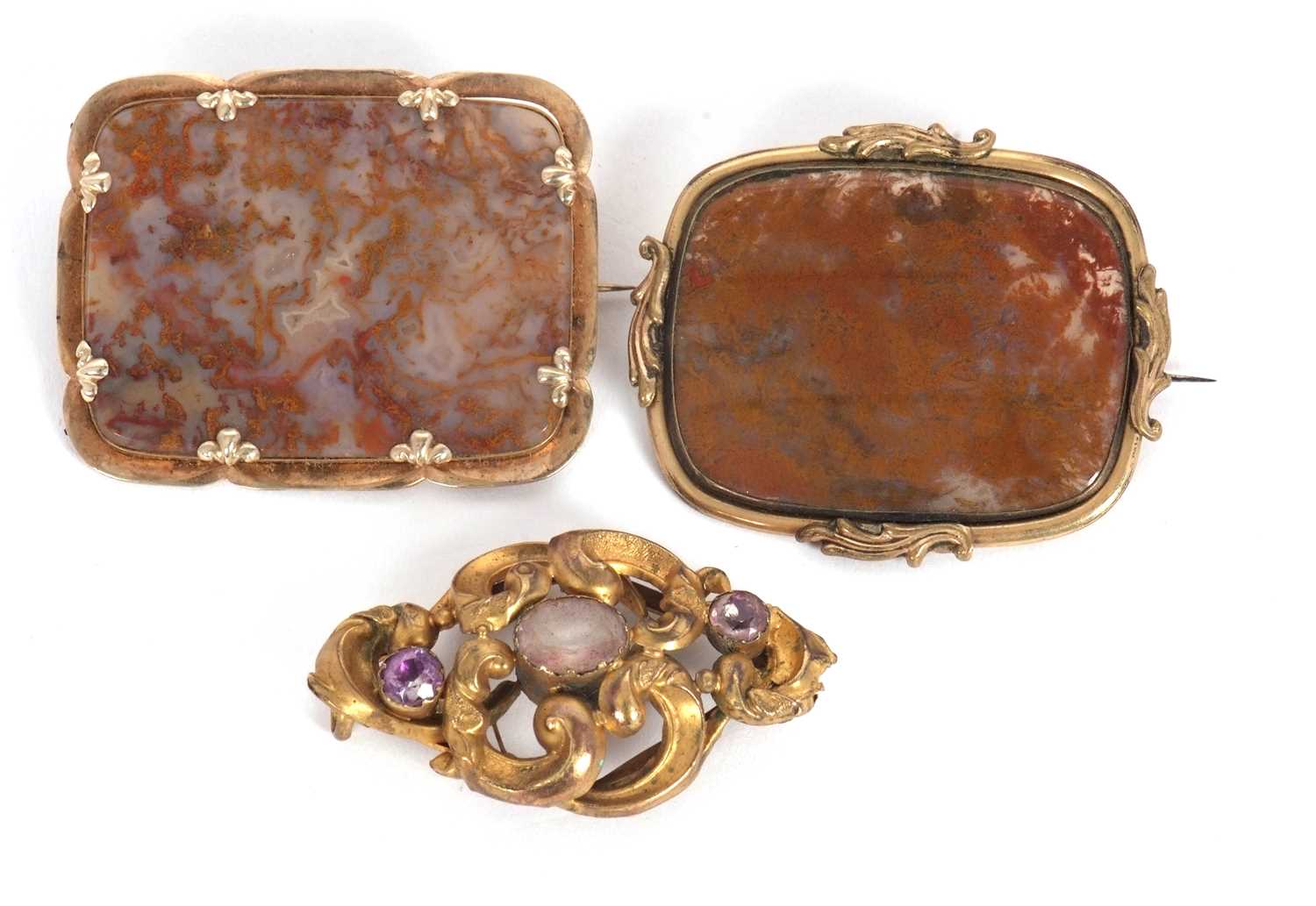 Lot 89 - Three brooches: to include an agate specimen...
