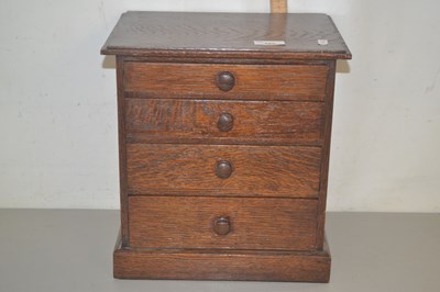 Lot 185 - A small oak chest with four drawers