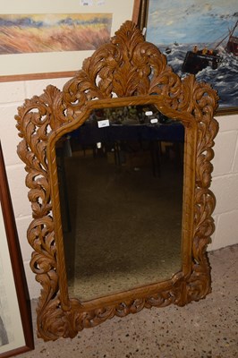 Lot 264 - A large mirror in carved wooden frame