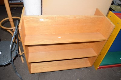 Lot 756 - A double sided bookshelf on casters