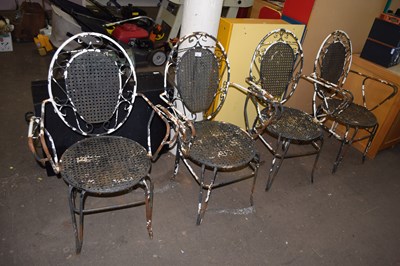 Lot 760 - A set of four iron outdoor chairs in need of...