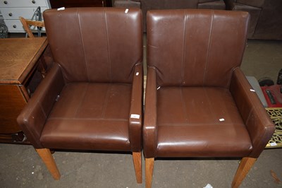 Lot 769 - A pair of brown leather effect armchairs