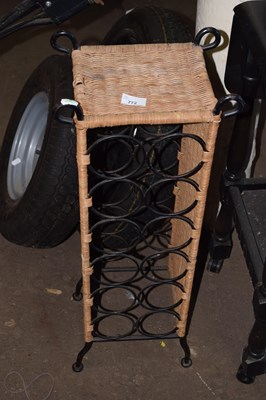 Lot 772 - A metal and wicker wine rack