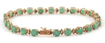 Lot 132 - An emerald bracelet, set with round emeralds,...