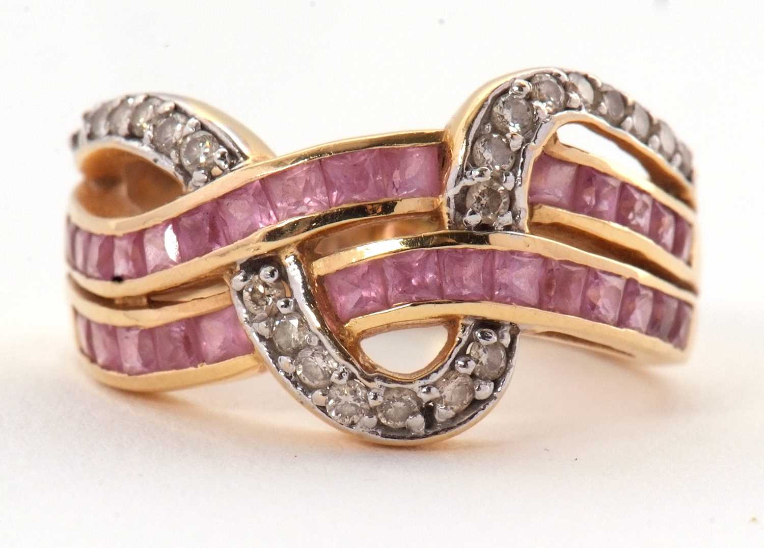 Lot 38 - An 18ct diamond and pink stone ring, set with...