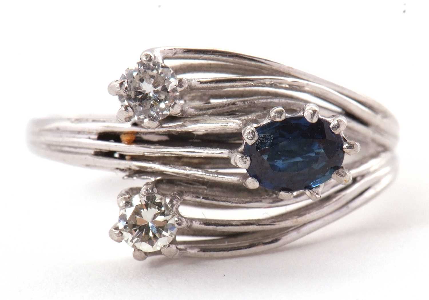 Lot 42 - A sapphire and diamond ring, set with an oval...