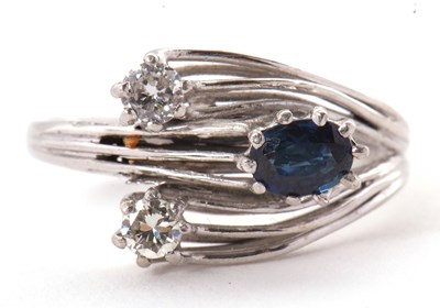 Lot 42 - A sapphire and diamond ring, set with an oval...