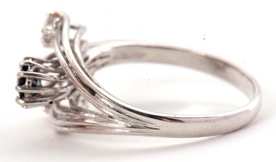 Lot 42 - A sapphire and diamond ring, set with an oval...