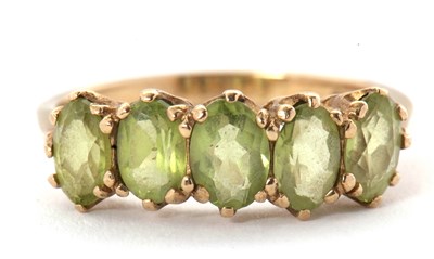 Lot 46 - A 9ct peridot ring, the five oval peridots...