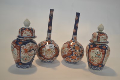 Lot 202 - A pair of Japanese Imari bottle shaped vases...
