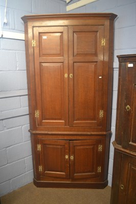 Lot 401 - A George III oak floor standing corner cabinet...
