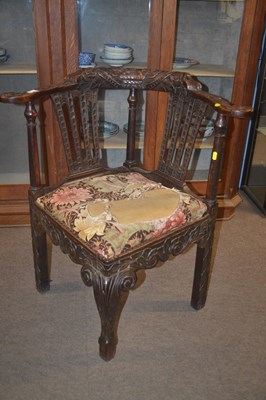 Lot 421 - A Victorian carved oak corner chair decorated...
