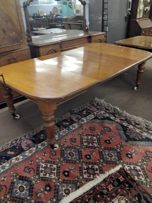 Lot 515 - A Victorian light oak extending dining table...