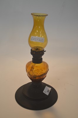 Lot 302 - Small oil lamp with amber coloured glass...