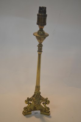 Lot 305 - A brass Regency style lamp base supported on...
