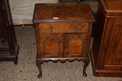 Lot 315 - A walnut veneered bedside cabinet on barley...