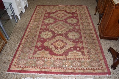 Lot 319 - A modern machine made floor rug with geometric...