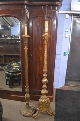 Lot 519 - A gilt wood standard lamp raised on a three...