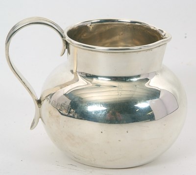 Lot 2 - A George V silver jug of plain baluster form...