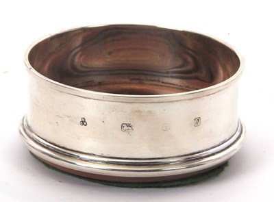 Lot 7 - An Elizabeth II silver bottle coaster of plain...