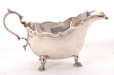 Lot 22 - A George V heavy silver sauce boat of typical...