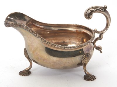 Lot 52 - An Edwardian silver sauce boat with gadrooned...