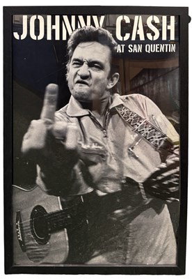 Lot 203 - A framed reproduction poster of Johnny Cash at...
