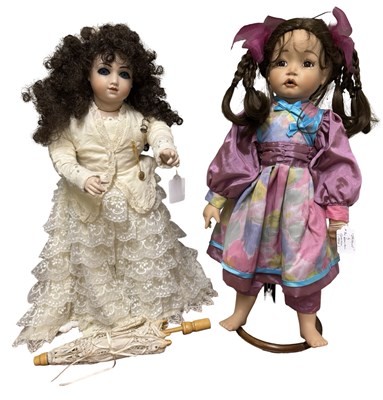 Lot 319 - A pair of porcelain collector's dolls, to...