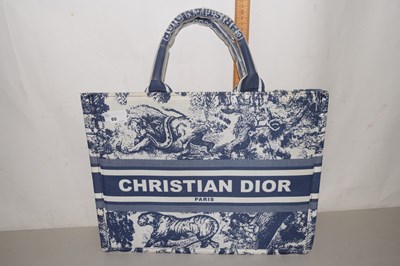 Lot 60 - A blue and white printed book tote bag, in...