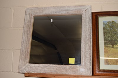 Lot 17 - A wall mirror in limed finish frame