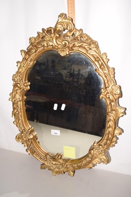 Lot 158 - Oval wall mirror in a Roccoco type frame