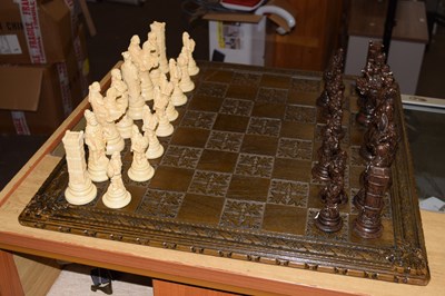 Lot 621 - A chess board and pieces