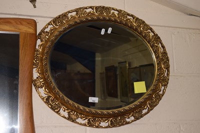 Lot 182 - Modern oval wall mirror in pierced gilt finish...